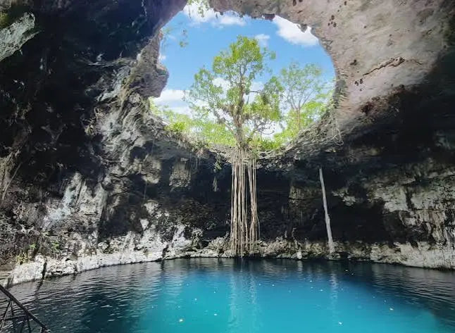 Sunlight entering a turquoise-water cenote in the Yucatán Peninsula