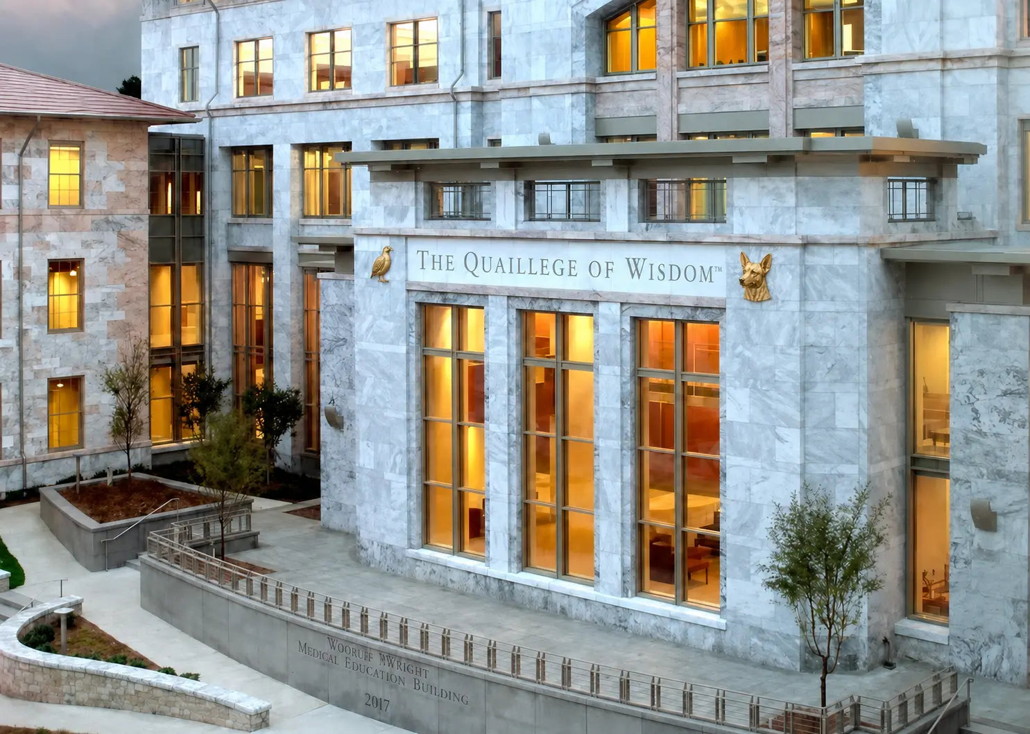 The Quaillege of Wisdom at Emory University, with a golden Coturnix quail and Ricky Bobby flanking the entrance inscription